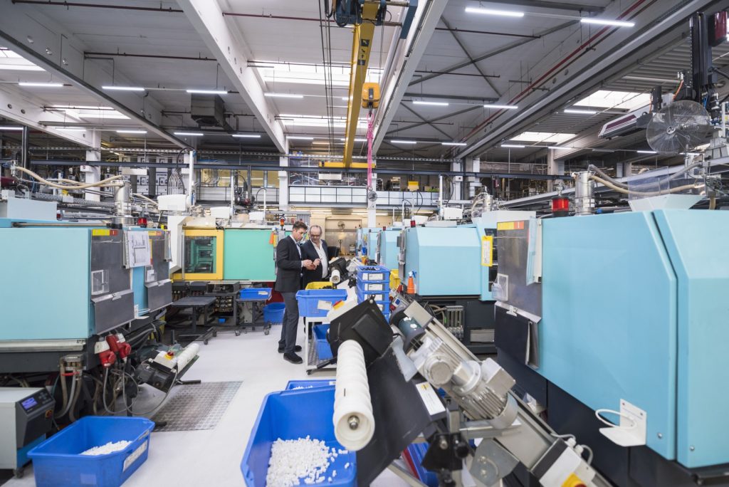 Two men talking in factory shop floor
