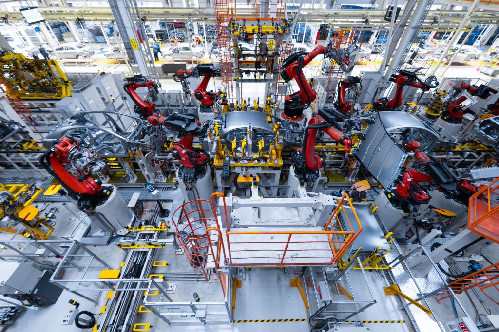 Assembly line production of new car. Automated welding of car body on production line. robotic arm on car production line is working