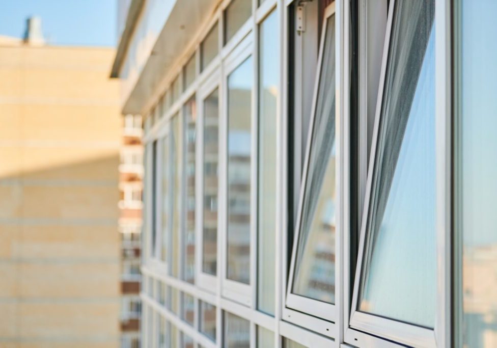 PVC windows on facade of skyscraper. Plastic double glazed windows. Building exterior.